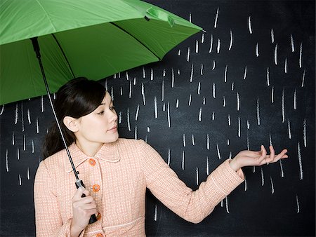 rain storm - woman in a chalkboard rainstorm Stock Photo - Premium Royalty-Free, Code: 640-02778266