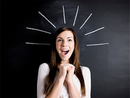 positive - young woman against a chalkboard Stock Photo - Premium Royalty-Free, Code: 640-02778315
