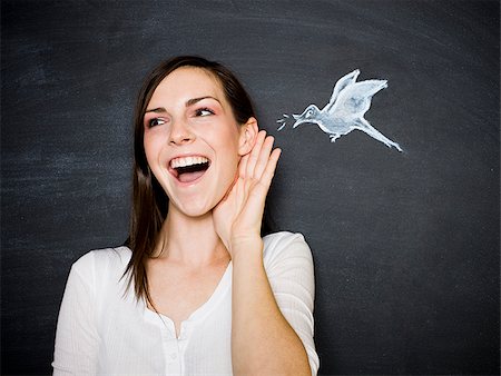 young woman against a chalkboard Stock Photo - Premium Royalty-Free, Code: 640-02778350