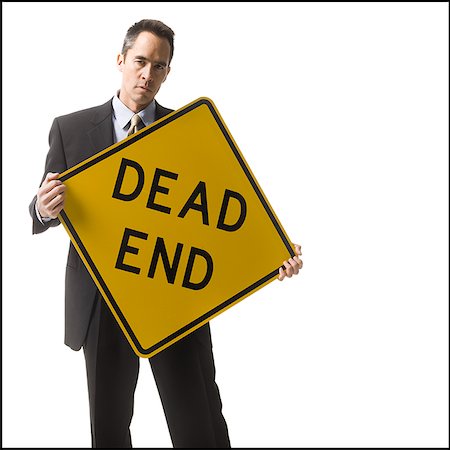 dead end sign - personne tenant une pancarte dead end Photographie de stock - Premium Libres de Droits, Code: 640-02778402