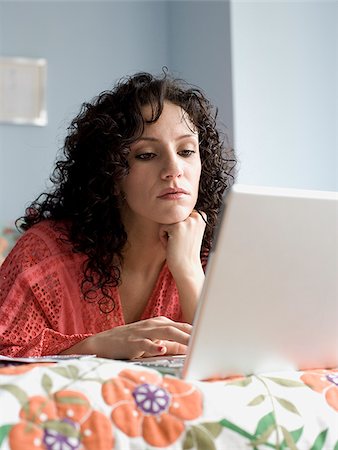 simsearch:640-02778481,k - femme allongée sur un lit avec un ordinateur portable Photographie de stock - Premium Libres de Droits, Code: 640-02778495
