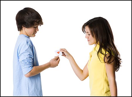 young couple passing a note Stock Photo - Premium Royalty-Free, Code: 640-02778563