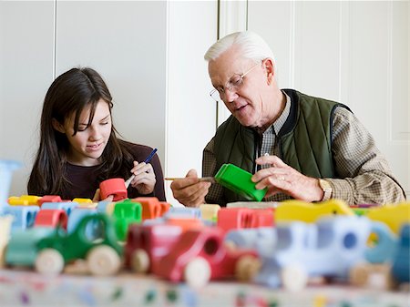 man and girl painting toys Stock Photo - Premium Royalty-Free, Code: 640-02778597