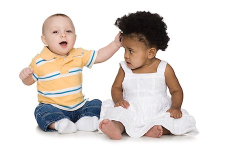 Two babies sitting Stock Photo - Premium Royalty-Free, Code: 640-02778804