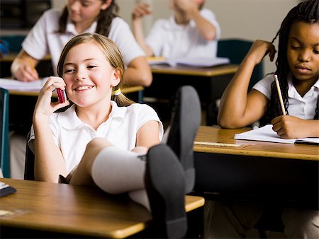 girl talking on phone in classroom Stock Photo - Premium Royalty-Free, Code: 640-02778958