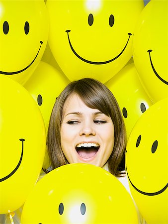 smiley - woman with smiley face balloons Stock Photo - Premium Royalty-Free, Code: 640-02779188