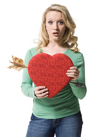 woman holding a heart with an arrow through it Fotografie stock - Premium Royalty-Free, Codice: 640-02779240