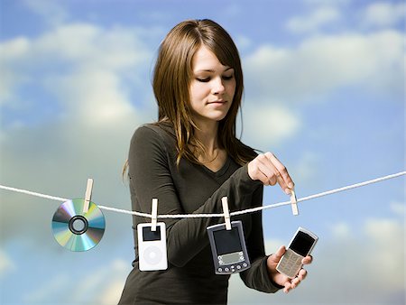 woman hanging electronics out to dry Stock Photo - Premium Royalty-Free, Code: 640-02779484