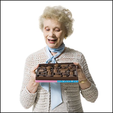 simsearch:640-01362854,k - Older woman holding a box of chocolates Stock Photo - Premium Royalty-Free, Code: 640-02770004