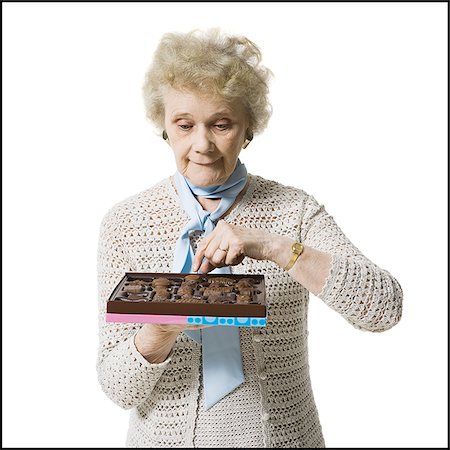 simsearch:640-01362854,k - Older woman holding a box of chocolates Stock Photo - Premium Royalty-Free, Code: 640-02770005