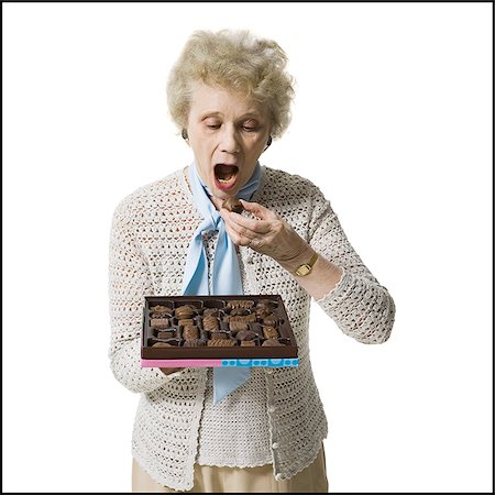 simsearch:640-01362854,k - Older woman holding a box of chocolates Stock Photo - Premium Royalty-Free, Code: 640-02770006