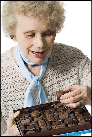 simsearch:640-01362854,k - Older woman holding a box of chocolates Stock Photo - Premium Royalty-Free, Code: 640-02770007