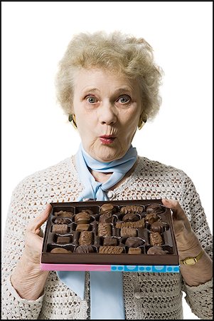 simsearch:640-01362854,k - Older woman holding a box of chocolates Stock Photo - Premium Royalty-Free, Code: 640-02770009