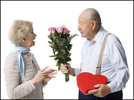 Older man giving wife Valentines chocolate Stock Photo - Premium Royalty-Free, Code: 640-02770010