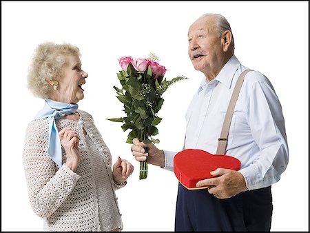 Older man giving wife Valentines chocolate Stock Photo - Premium Royalty-Free, Code: 640-02770011
