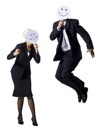 simsearch:632-05604250,k - Businessman and businesswoman holding expression masks Stock Photo - Premium Royalty-Free, Code: 640-02770096