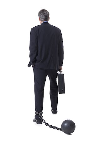 Businessman shackled to ball and chain Stock Photo - Premium Royalty-Free, Code: 640-02770205