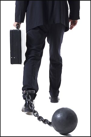 Businessman shackled to ball and chain Stock Photo - Premium Royalty-Free, Code: 640-02770206