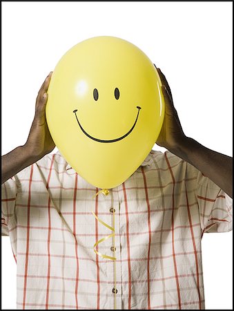 simsearch:640-03265307,k - Man holding a happy face balloon Foto de stock - Sin royalties Premium, Código: 640-02770207