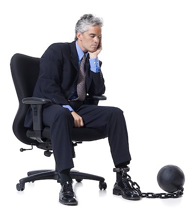 Businessman shackled to ball and chain Stock Photo - Premium Royalty-Free, Code: 640-02770201