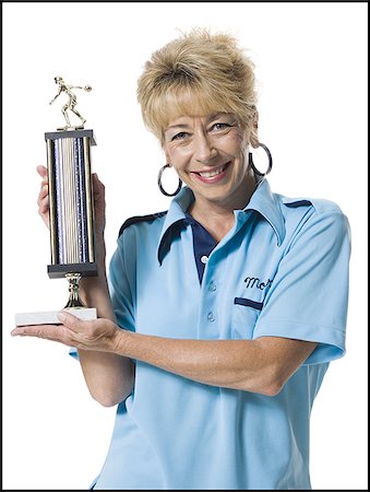 Female bowler holding trophy Stock Photo - Premium Royalty-Free, Code: 640-02770299
