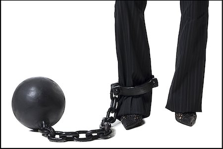 Businesswoman shackled to ball and chain Stock Photo - Premium Royalty-Free, Code: 640-02770327