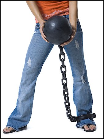 female inmate restrain - Woman shackled to ball and chain Stock Photo - Premium Royalty-Free, Code: 640-02770337