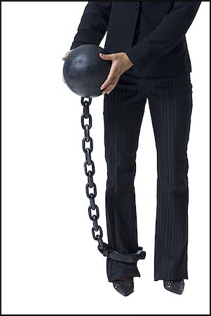 Businesswoman shackled to ball and chain Stock Photo - Premium Royalty-Free, Code: 640-02770330