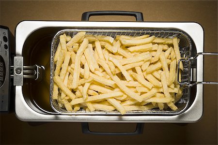 deep fry - Close-up of French fries cooking Stock Photo - Premium Royalty-Free, Code: 640-02770385