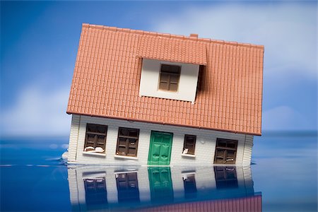 Flooded toy house floating in water Stock Photo - Premium Royalty-Free, Code: 640-02770483