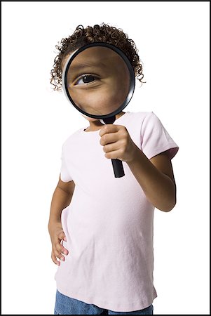 Young girl looking through magnifying glass Stock Photo - Premium Royalty-Free, Code: 640-02770506