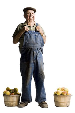 Farmer posing with baskets of apricots Stock Photo - Premium Royalty-Free, Code: 640-02770616