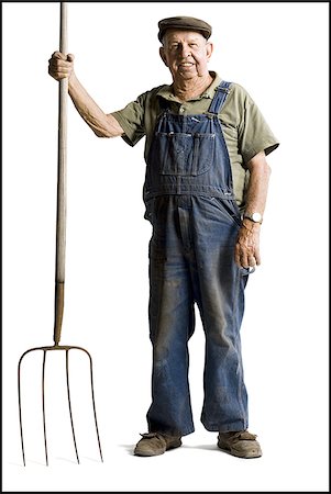 Farmer holding a pitchfork Stock Photo - Premium Royalty-Free, Code: 640-02770613