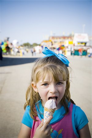 Young girl eating ice cream cone Stock Photo - Premium Royalty-Free, Code: 640-02770745