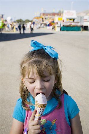 Young girl eating ice cream cone Stock Photo - Premium Royalty-Free, Code: 640-02770743