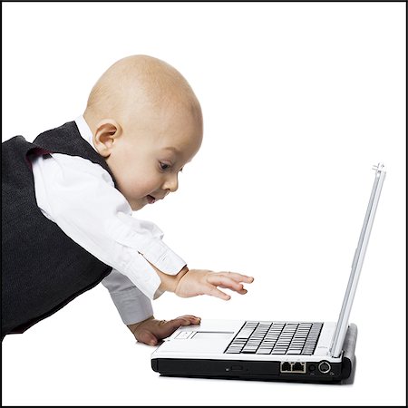 prodigio - Baby boy in suit with laptop Fotografie stock - Premium Royalty-Free, Codice: 640-02770862