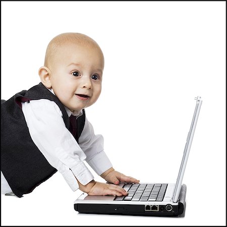prodigio - Baby boy in suit with laptop Fotografie stock - Premium Royalty-Free, Codice: 640-02770863