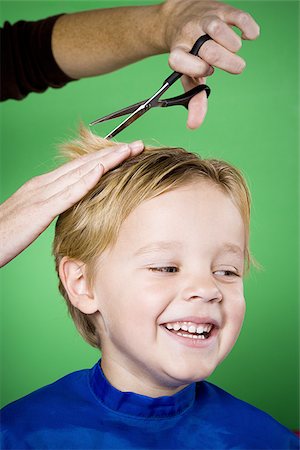 Boy having his hair cut smiling Stock Photo - Premium Royalty-Free, Code: 640-02770898