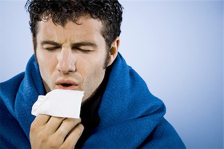 sneeze cold - Man wrapped in blanket with tissue Stock Photo - Premium Royalty-Free, Code: 640-02770912