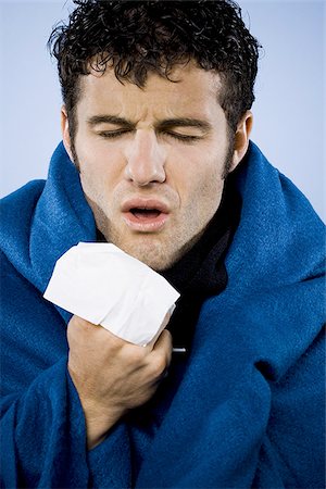 sneeze cold - Man wrapped in blanket with tissue Stock Photo - Premium Royalty-Free, Code: 640-02770913