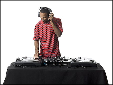 DJ with headphones spinning records Stock Photo - Premium Royalty-Free, Code: 640-02771108