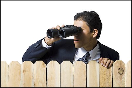 simsearch:640-02771261,k - Businessman looking through binoculars over wooden fence Stock Photo - Premium Royalty-Free, Code: 640-02771245