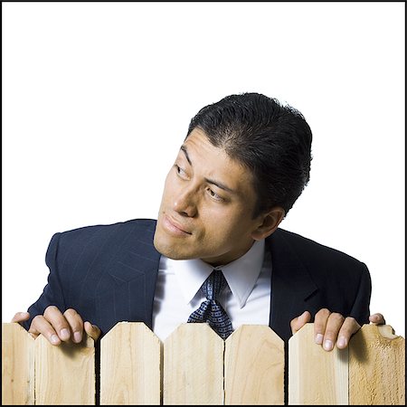simsearch:640-02771261,k - Businessman looking over wooden fence Stock Photo - Premium Royalty-Free, Code: 640-02771240