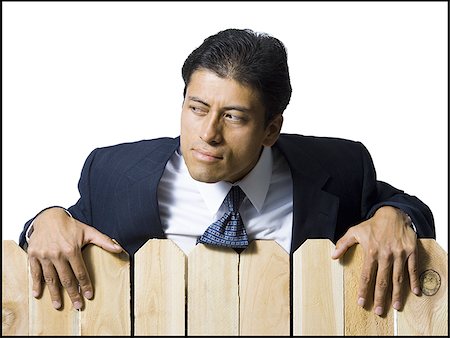 simsearch:640-02771261,k - Businessman looking over wooden fence Stock Photo - Premium Royalty-Free, Code: 640-02771241
