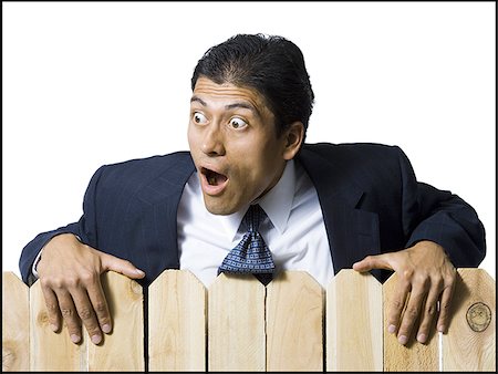 simsearch:640-02771261,k - Businessman looking over wooden fence Stock Photo - Premium Royalty-Free, Code: 640-02771242