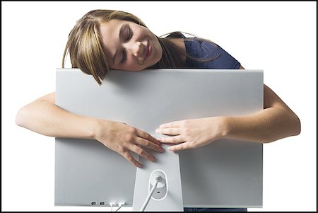 Girl resting on computer monitor smiling Stock Photo - Premium Royalty-Free, Code: 640-02771311