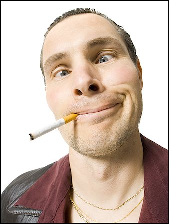 Man in sunglasses smoking cigarette Stock Photo - Premium Royalty-Free, Code: 640-02771358