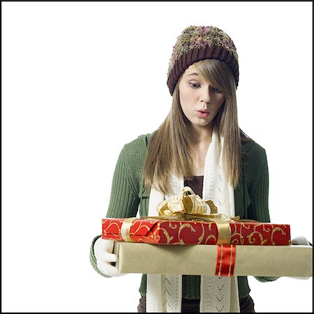 Girl looking at Christmas presents Stock Photo - Premium Royalty-Free, Code: 640-02771413