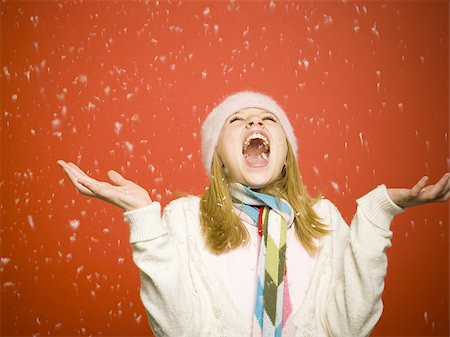 red scarf woman - Girl looking up at snow Stock Photo - Premium Royalty-Free, Code: 640-02771421