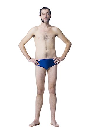 racing brief - Man standing in swimsuit smiling Stock Photo - Premium Royalty-Free, Code: 640-02771504